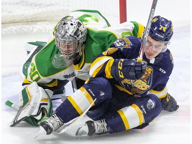 Noah Sedore of the Erie Otters crashes into London Knight netminder Brett Brochu during the first period of their OHL hockey game in London, Ont. on Saturday November 2, 2019. Derek Ruttan/The London Free Press/Postmedia Network