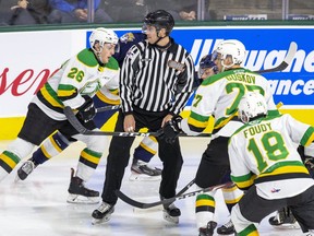 OHL linesman Blake Beer works a game between the London Knights and Erie Otter in London. (Derek Ruttan/The London Free Press)
