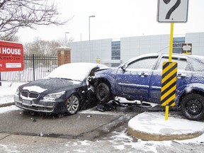 Even though it was not on a road, a -two-vehicle collision at an Oxford Street entrance to Fanshawe College snarled traffic in London, Ont. on Monday November 11, 2019 as tow trucks blocked the right lane and drivers slowed to look at the wreckage.  Derek Ruttan/The London Free Press/Postmedia Network