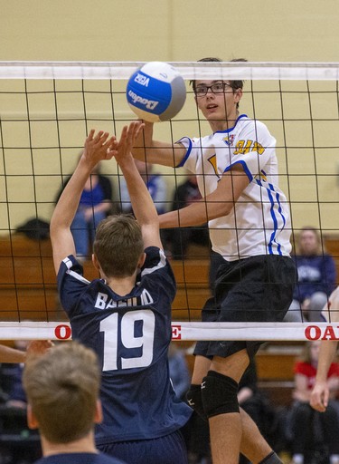 Oakridge's Stanley Rayevskiy hits the ball past CCH's Sam Basilio during the WOSSAA junior volleyball final at Oakridge secondary school in London on Wednesday. Oakridge took the gold medal in three sets, 25-11, 25-7 and 25-13. (DEREK RUTTAN/The London Free Press)
