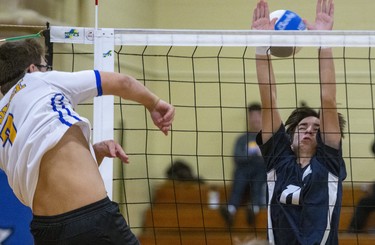 Oakridge's Kyle Van Nest hits the ball past CCH's Chris Di Marco during the WOSSAA  AAA junior volleyball final at Oakridge secondary school in London on Wednesday. Oakridge took the gold medal in three sets, 25-11, 25-7 and 25-13. (DEREK RUTTAN/The London Free Press)