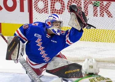 Kitchener Ranger goalie Nathan Torchia gets just enough of the puck to deflect it wide of the net during the second period of their game against the London Knights in London, Ont. on Sunday November 17, 2019. Derek Ruttan/The London Free Press/Postmedia Network