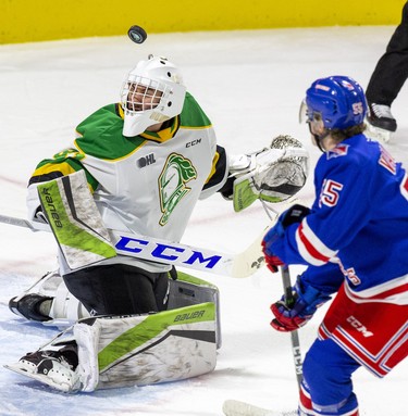 The puck bounces off the head of London Knights goalie Dylan Myskiw after ringing off the crossbar during the second period of their game against the Kitchener Rangers in London, Ont. on Sunday November 17, 2019. Derek Ruttan/The London Free Press/Postmedia Network