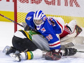 London Knight Luke Evangelista crashes into Kitchener Rangers goalie Nathan Torchia during the first period of their game  in London, Ont. on Sunday November 17, 2019. (Derek Ruttan/The London Free Press)