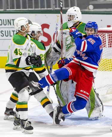 Kitchener Ranger Justin MacPherson is toppled by Ryan Merkley of the London Knights following a whistle in the third period of their game  in London, Ont. on Sunday November 17, 2019. Also in the crease at Gerard Keane (45) and Dylan Myskiw.  Derek Ruttan/The London Free Press/Postmedia Network