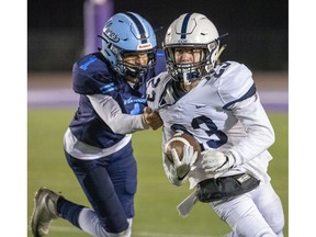 Lucas Vikings player Moaaz Moustafa grabs Catholic Central ball carrier Luke Ciapka during the WOSSAA senior football championship game at TD Stadium in London on Thursday Nov. 21, 2019. (Derek Ruttan/The London Free Press)