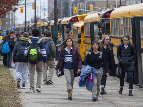 Students leave Catholic Central secondary school last week. Public high school and elementary teachers begin a work-to-rule campaign Tuesday they say will target ministry and school board administrative tasks and won't affect students. Catholic teachers, whose union accused the government of throwing negotiations "into complete chaos," have applied for a conciliator to help in talks. (Derek Ruttan/The London Free Press)