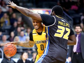 Maurice Bolden of the London Lightning tries to drive in against Randy Phillips of the Saint John Riptide during their game at Budweiser Gardens in London on Sunday January 13, 2019. (Mike Hensen/The London Free Press)