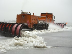 London airport operations staff push snow and slush off one of their runways at the airport on Wednesday February 6, 2019. Mike Hensen/The London Free Press