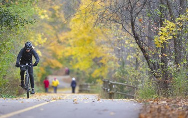Tammy Sheffar heads homeward from Springbank Park on the multi-use pathway near Wonderland Gardens. Sheffar, a longtime Central Secondary Cross-country coach uses the bike to get a workout in on alternate days with running. Mike Hensen/The London Free Press