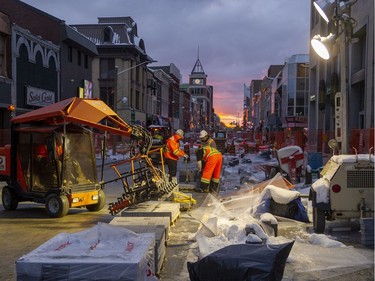 Working after sundown Friday, London's First Choice Interlock brings in extra lights to continue laying interlocking brick that will cover the flex street in London. (Mike Hensen/The London Free Press)