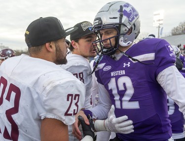 A dejected Chris Merchant, quarterback for the Western Mustangs, shakes hands with Jordan Lyons and Xander Tachinski of the the victorious McMaster Marauders, who won the Yates Cup 29-15 in a dominating display at TD Stadium on Saturday November 9, 2019. 
Mike Hensen/The London Free Press/Postmedia Network