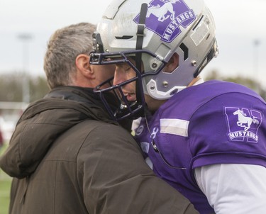 Peter Merchant consoles his son, Chris Merchant of the Western Mustangs, after they lost to the McMaster Mauraders in the Yates Cup 29-15 at TD stadium on Saturday November 9, 2019. 
Mike Hensen/The London Free Press/Postmedia Network