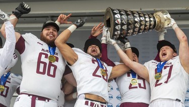 McMaster Maruders Jakub Szott, Jordan Lyons, Lucas Bill and Eric Blake hoist the Yates Cup on Saturday November 9, 2019 after defeating the Western Mustangs 29-15. Mike Hensen/The London Free Press/Postmedia Network