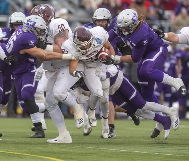 McMaster's Jordan Lyons runs behind the blocking of lineman Wyatt Croucher  before being stopped by the Mustangs defense during the Yates Cup at TD stadium on Saturday November 9, 2019. The Marauders beat the undefeated Mustangs 29-15 to win the Yates Cup.
Mike Hensen/The London Free Press/Postmedia Network