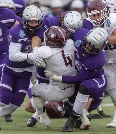 Western's Zach Lindley, Tony Rossi and Deointe Knight combine to tackle Justice Allin of the McMaster Marauders during the Yates Cup championship game Saturday November 9, 2019 at Western. McMaster dominated the game, winning 29-15.
Mike Hensen/The London Free Press/Postmedia Network