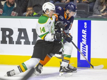 Luke Evangelista of the Knights checks Evgenly Oksentyuk of the Flint Firebirds in the first period of their game at Budweiser Gardens on Friday November 15, 2019.  Mike Hensen/The London Free Press/Postmedia Network