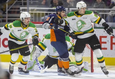 Hunter Skinner of the Knights pushes Evgenly Oksentyuk of the Flint Firebirds who was in front of Knights goaltender Dylan Myskiw  with Ryan Merkley  in the first period of their game at Budweiser Gardens on Friday November 15, 2019.  Mike Hensen/The London Free Press/Postmedia Network