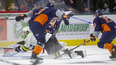 Liam Foudy of the Knights gets tripped for a penalty by #11 Dennis Busby in front of Flint goaltender Luke Cavallin late in the first period of their game at Budweiser Gardens on Friday November 15, 2019.  Mike Hensen/The London Free Press/Postmedia Network