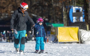 Jamie Thibert tows his daughter Adrianna, 6, to the beginners hill so she can ski all by herself during the first weekend of operation at Boler Mountain in London. The non-profit opened their 73rd year Saturday, their earliest opening in 30 years. Mike Hensen/The London Free Press/Postmedia Network