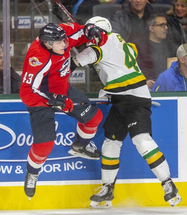 Windsor's Louka Henault gets rocked by Jonathan Gruden of the Knights during the first period of their OHL game Friday night at Budweiser Gardens in London. Photograph taken on Friday November 29, 2019. 
Mike Hensen/The London Free Press/Postmedia Network