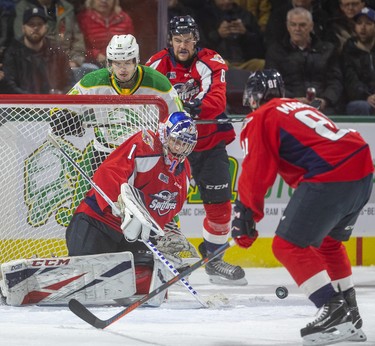 London Knights forward Connor McMichael looks for the puck from behind the Windsor Spitfires net while being checked by Connor Corcoran as goaltender Kari Piiroinen can't control the rebound Friday night at Budweiser Gardens in London. Photograph taken on Friday November 29, 2019. 
Mike Hensen/The London Free Press/Postmedia Network