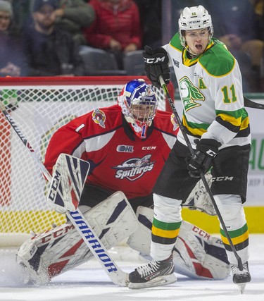 London Knights forward Connor McMichael looks for the puck while screening Windsor Spitfires goaltender Kari Piiroinen during the first period of their OHL game Friday night at Budweiser Gardens in London. Photograph taken on Friday November 29, 2019. Mike Hensen/The London Free Press/Postmedia Network