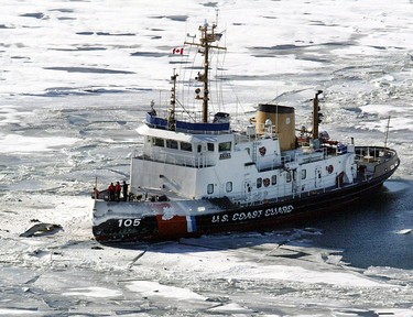 Unidentified debris from a plane sits above the ice, left, as the US Coast Guard Cutter Neah Bay posts itself outside of the site where a charter flight from Pelee Island to Windsor Airport crash-landed on January 17, 2004 about a half-a-mile off the island into Lake Erie, killing 10 people. (Tim Fraser/Windsor Star)