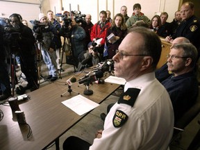 From left, OPP Inspector Chris Sharpe, the Transportation Safety Board's Denis Rivard and OPP incident commander Doug Babbitt speak at a news conference concerning recovery efforts for the Pelee Island plane crash, on Monday Jan. 19, 2004 in Kingsville, Ont. (The Windsor Star/Dan Janisse)