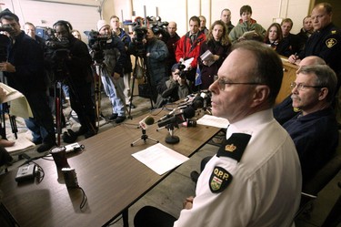 From left, O.P.P. Inspector Chris Sharpe, Transportation Safety Board's Denis Rivard and O.P.P. incident commander Doug Babbitt speak at a news conference concerning recovery efforts for the Pelee Island plane crash, on Monday Jan. 19, 2004 in Kingsville, Ont. (The Windsor Star - Dan Janisse)