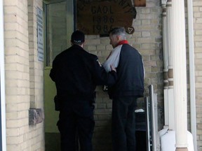 David Smith is taken into jail on Friday in Stratford after being sentenced to five years for sexually touching young girls at his wife's home daycare over several years. Terry Bridge/Stratford Beacon Herald/Postmedia Network