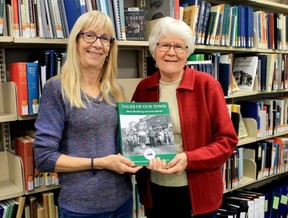 Strathroy and District Historical Society members Aileen Cnockaert and Libby McLachlan stand with a copy of Tales of our Town: More Strathroy and Area Stories, which will be officially launched next Thursday during an event at the Strathroy Library at 7 p.m. (Carl Hnatyshyn, Postmedia Network)