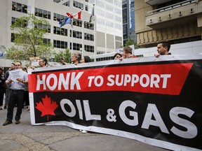 Oil and gas industry supporters rally outside the venue where Finance Minister Bill Morneau addresses an Economic Club of Canada breakfast in Calgary, Wednesday, June 19, 2019. "Let’s not kid ourselves: extraction of fossil fuels and the massive subsidies and financial resources poured into marketing them drive the climate crisis," Richard Janda writes.