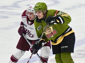 Keegan McMullen of the Peterborough Petes leans into Alex Christopoulos of the North Bay Battalion in first-period action in their Ontario Hockey League game. Postmedia file photo
