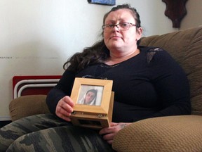 Krista Mulholland holds a picture of her son Tyler McMichael, who has been missing for more than six months in London.  (Jonathan Juha/The London Free Press)
