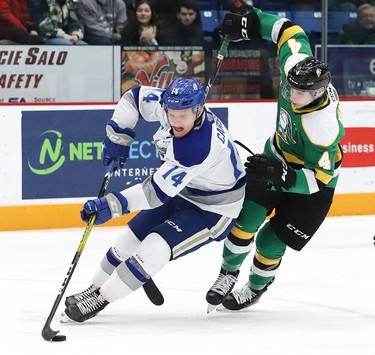 Macauley Carson, left, of the Sudbury Wolves, skates around Avery Winslow, of the London Knights, during OHL action at the Sudbury Community Arena in Sudbury, Ont. on Friday December 20, 2019. John Lappa/Sudbury Star/Postmedia Network