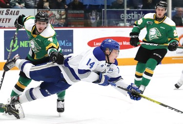 Macauley Carson, of the Sudbury Wolves, is tripped up during OHL action against the London Knights at the Sudbury Community Arena in Sudbury, Ont. on Friday December 20, 2019. John Lappa/Sudbury Star/Postmedia Network