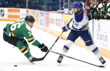 David Levin, right, of the Sudbury Wolves, passes the puck past Billy Moskal, of the London Knights, during OHL action at the Sudbury Community Arena in Sudbury, Ont. on Friday December 20, 2019. John Lappa/Sudbury Star/Postmedia Network