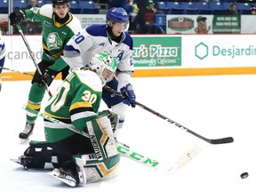 Shane Bulitka, of the Sudbury Wolves, looks for a rebound against London Knights goalie Brett Brochu, under pressure from Knights defenceman Kirill Steklov during OHL action at the Sudbury Community Arena in Sudbury, Ont. on Friday Dec. 20, 2019. John Lappa/Postmedia Network