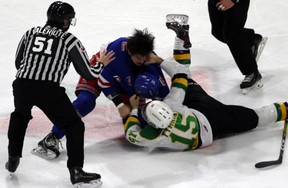 London Knights Cole Tymkin hits Kitchener Rangers Arber Xhekaj during a fight with in London on Dec. 28. (Greg Colgan/Postmedia Network)