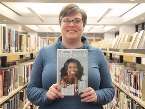 Librarian Kristen Caschera, who heads London Public Library’s readers’ advisory team, holds a copy of Becoming by former first lady Michelle Obama, the most borrowed book by Londoners in 2019. (Jonathan Juha/The London Free Press)