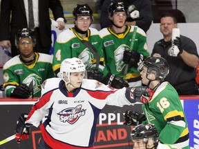 Windsor Spitfires Louka Henault, left, tangles with London Knights Sean McGurn at WFCU Centre in Windsor Sunday. Henault drew a minor penalty on the play. (NICK BRANCACCIO/Windsor Star)