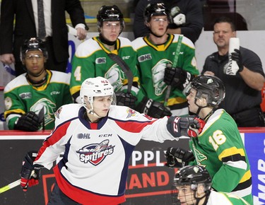 Windsor, Ontario Dec. 15, 2019.  Windsor Spitfires Louka Henault, left, tangles with London Knights Sean McGurn at WFCU Centre in Windsor Sunday. Henault drew a minor penalty on the play. (NICK BRANCACCIO/Windsor Star)