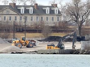 Heavy machinery continues to work on the Detroit, Michigan coastline at Detroit Bulk Storage Wednesday. Historic Fort Wayne is shown behind.