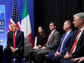 U.S. President Donald Trump speaks as U.S. Defense Secretary Mark Esper and Acting White House Chief of Staff Mick Mulvaney look on during a bilateral meeting with Italian Prime Minister Giuseppe Conte on the sidelines of the NATO summit in Watford, Britain, December 4, 2019. REUTERS/Kevin Lamarque