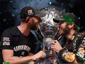 Martin Truex Jr., driver of the #78 Bass Pro Shops/Tracker Boats Toyota, celebrates with crew chief Cole Pearn and the trophy in Victory Lane after winning the Monster Energy NASCAR Cup Series Championship and the Monster Energy NASCAR Cup Series Championship Ford EcoBoost 400 at Homestead-Miami Speedway on November 19, 2017 in Homestead, Florida.  (Photo by Jared C. Tilton/Getty Images)