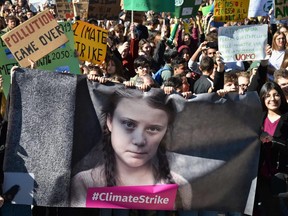 Students and others hold a banner showing 16-year-old Swedish environmental activist Greta Thunberg, their inspiration in pushing political leaders to fight climate change, as they take part in a protest in Rome in March. (Andreas Solaro/AFP via Getty Images)