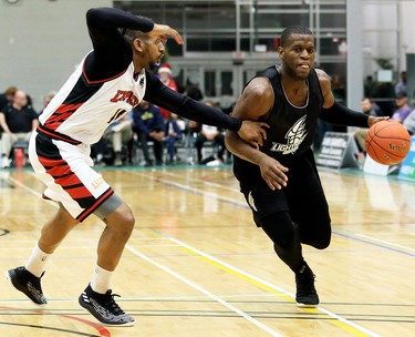 London Lightning's Abednego Lufile, right, drives to the basket against Windsor Express's Deilvez Yearby in the second half of a National Basketball League of Canada exhibition game at St. Clair College's Chatham Campus HealthPlex in Chatham, Ont., on Saturday, Dec. 14, 2019. Mark Malone/Chatham Daily News/Postmedia Network