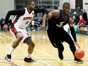 London Lightning's Abednego Lufile, right, drives to the basket against Windsor Express's Deilvez Yearby in the second half of a National Basketball League of Canada exhibition game at St. Clair College's Chatham Campus HealthPlex in Chatham, Ont., on Saturday, Dec. 14, 2019. (Mark Malone/Postmedia Network)