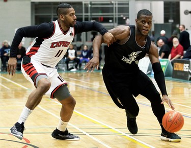 London Lightning's Abednego Lufile, right, drives to the basket against Windsor Express's Deilvez Yearby in the second half of a National Basketball League of Canada exhibition game at St. Clair College's Chatham Campus HealthPlex in Chatham, Ont., on Saturday, Dec. 14, 2019. Mark Malone/Chatham Daily News/Postmedia Network
